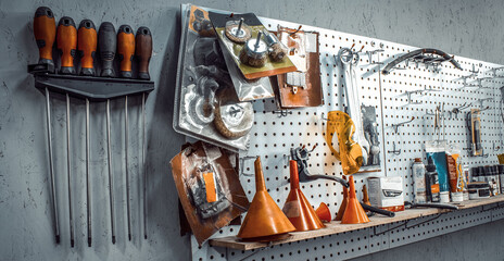 Inside workshop. tools kit for working on steel wall close-up. Workspace for mechanic with screwdrivers, pliers on a metal wall. Garage for motorcycle repair, car service station. Banner for web site