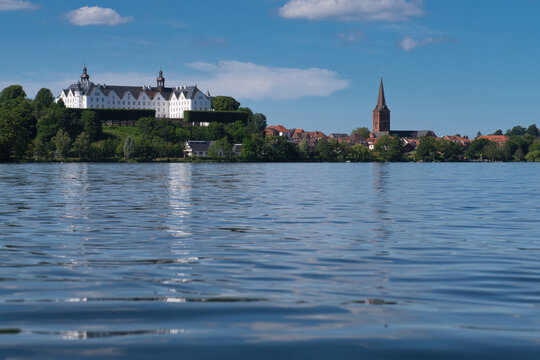 Skyline, view from great ploner ploener lake to plon castle and church Nikolaikirche in Germany, Ploen