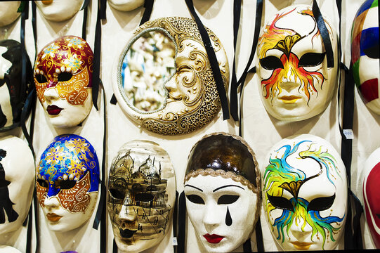 Exhibition of masks of various colors, made by hand, with different emotional expressions, traditional products of Venice. Tourist products. Italy.