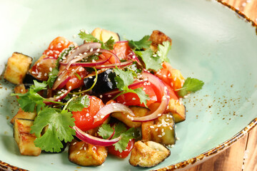 eggplant salad with sesame seeds and tomatoes closeup