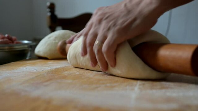 preparing  pastry for baking with hands and roler