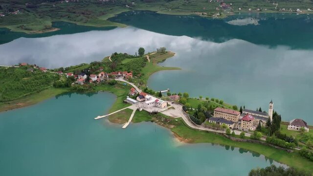 Fly over drone shot of the Saint Franciscan monastery at Rama Lake.
