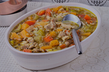 Healthy chicken stew in a white oven dish.