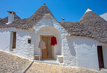 Alberobello is a small town near Bari, Apulia, southern Italy.  Old town Alberobello is famous for its unique trullo buildings. - obrazy, fototapety, plakaty