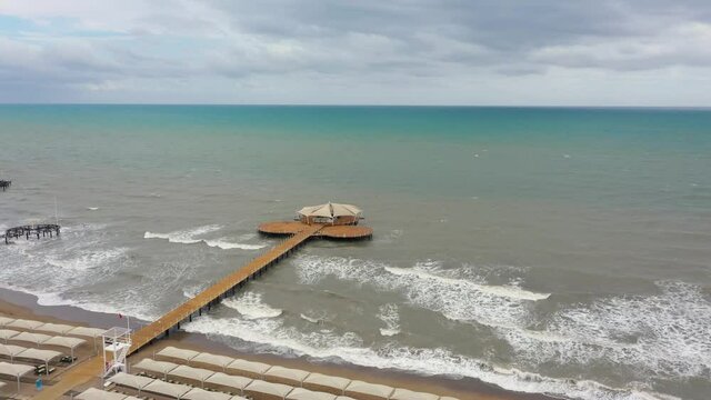 Aerial view of sea waves reaching sandy beach. Pierce in the middle of Meditteranean. Drone footage 