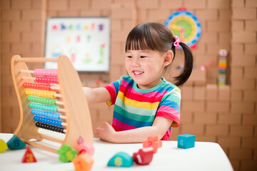 toddler girl learn counting by using abacus for homeschooling