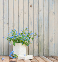 Blue Forget-me-nots flowers on wooden table. Vintage floral background
