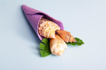 Seashells in an ice cream cone. The concept of summer, vacation, sea