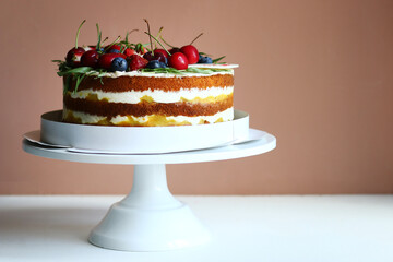 biscuit cake with berries on light background. cake with sweet cherry and blueberry