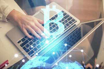 Double exposure of woman hands typing on computer and crypto market theme hologram drawing....