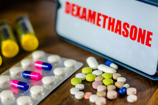 In this photo illustration pharmaceutical pills are seen displayed on a table with a Dexamethasone inscription on the background. Medically corticoid is used to treat COVID-19 (coronavirus).