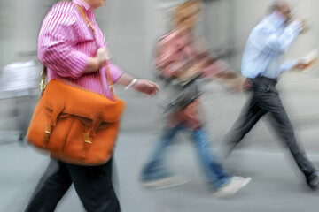 motion blurred business people walking on the street