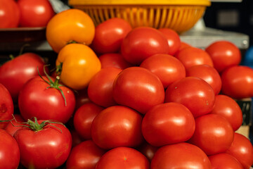 Red and yellow tomatoes on the market. Purchase.