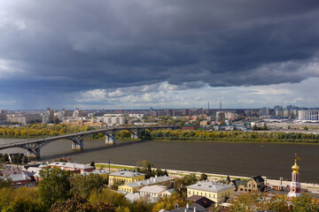 Fototapeta na wymiar Nizhny Novgorod, Russia - September 17, 2019. Panorama of the city. Kanavinsky bridge over the Oka. Thunder Sky.