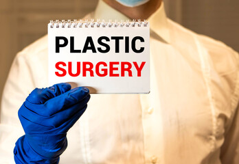 Plastic Surgery Concept written on a card in doctors hands