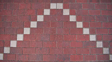 background of red and white paving stones in the shape of an arrow