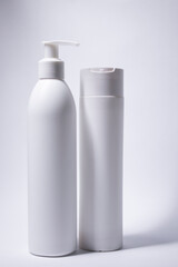  two white shampoo bottles and no label. body care and beauty concept. Copy space. High quality photo