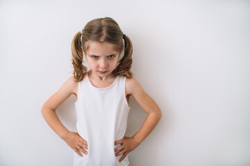portrait of angry blonde girl on white background