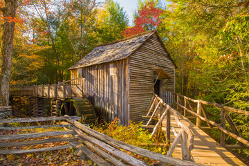 Great Smoky Mountains National Park, Tennessee, a historic water wheel and  grist mill with a split rail fence.