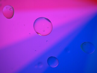 Closeup blue purple oil bubbles with colorful background and blurred ,macro image ,sweet color...
