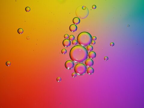 Closeup oil bubbles with colorful background and blurred droplets ,macro image ,sweet pastel color ,rainbow and colorful balloons background, abstract background