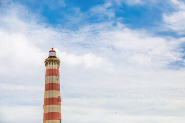 Praia da Barra lighthouse in Aveiro, Portugal. It is the highest lighthouse in Portugal with a height of 62 meters above the beach of the barrier and prone to Atlantic storms