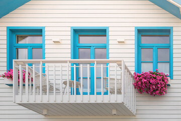 Colored window and balcony in typical small wooden house with colorful stripes in Costa Nova, Aveiro, Portugal. Detail of the house in famous resort Costa Nova