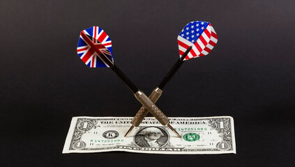 Dollar and darts with british and american flags on black