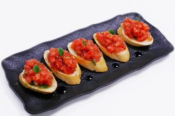 classic tomato bruschetta, fresh tomato cubes marinated in olive oil and basil with bread crouton
