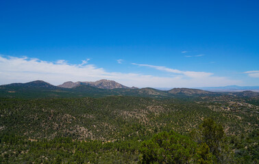 Fototapeta na wymiar The views from the top of the trail on Prescott, Arizona's Thumb Butte. In the distance you can see Granite Mountain, and the San Francisco Peaks.