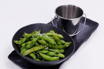 Boiled green soybeans in the pod known as edamame