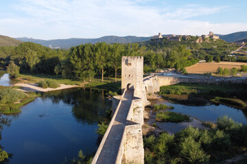 Fototapeta na wymiar Aerial view of a medieval stone bridge over Ebro river in Frias, historic village in the province of Burgos, Spain. High quality 4k footage