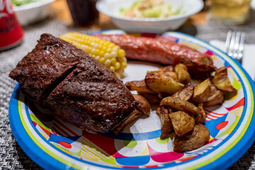 Home made BBQ dinner with steak, corn, chorizo and potatoes