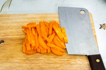 Flat lay fresh carrots with knife Cut the pieces on the cutting board.