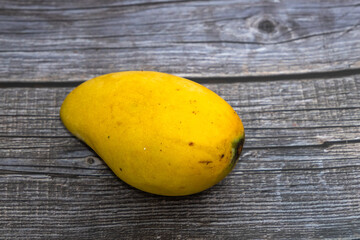 Sweet ripe mango fruits over wooden table