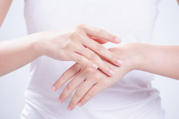 Fototapeta na wymiar closeup of female hands applying hand cream,Lotion