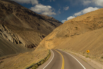 Travel. Driving along the asphalt route 40 in the yellow mountains, on the way to mount Aconcagua in Mendoza, Patagonia Argentina.  