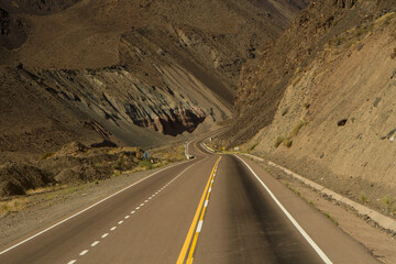 Traveling along the asphalt highway across the mountains and desert.