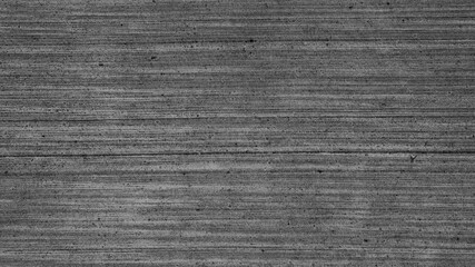 Background texture of concrete with textured brushed finish. Contrast grey brush concrete texture. Concrete pavement. Gray cement slab texture