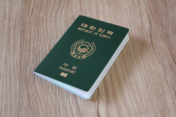 Republic of Korea passport on wooden texture