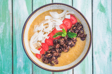 Smoothie bowl with coconut strawberries and granola 