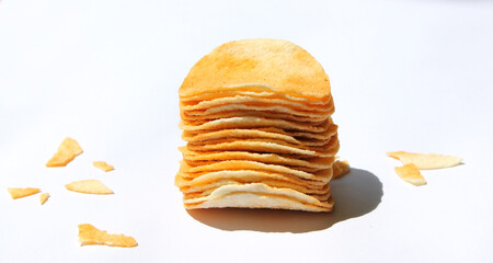 potato chips tower  and crumbs isolated on white background. snack