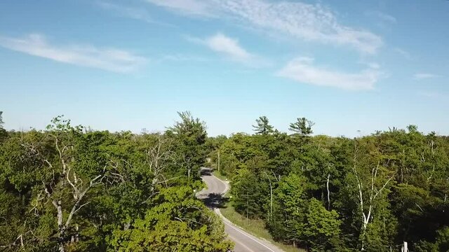 Aerial Drone Video Flying Over a Winding Road Forest in Door County Wisconsin