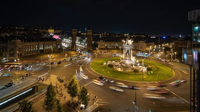 Barcelona, Spain, zoom in timelapse view of traffic around Plaza Espanya historical square at night.
