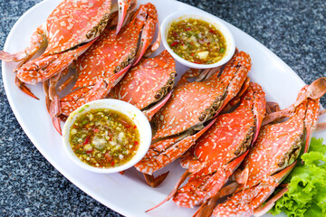 Steamed crab in a dish with 
seafood sauce. - Pattaya, Thailand.