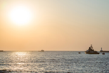 Fototapeta na wymiar Sunset in Sevastopol overlooking the military ships of the Russian Navy