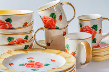 Cups, plates, bowls on white background