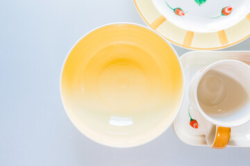 Cups, plates, bowls on white background