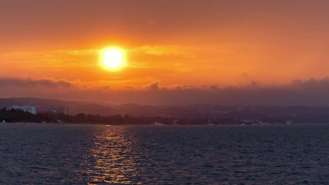 Orange Sunset Over Coastline. Time Lapse.