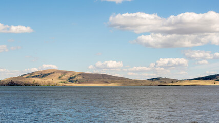 Lake among the Ural mountains, cloudy sky